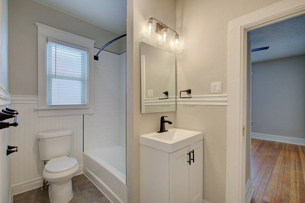 a bathroom with a toilet and a sink and a mirror