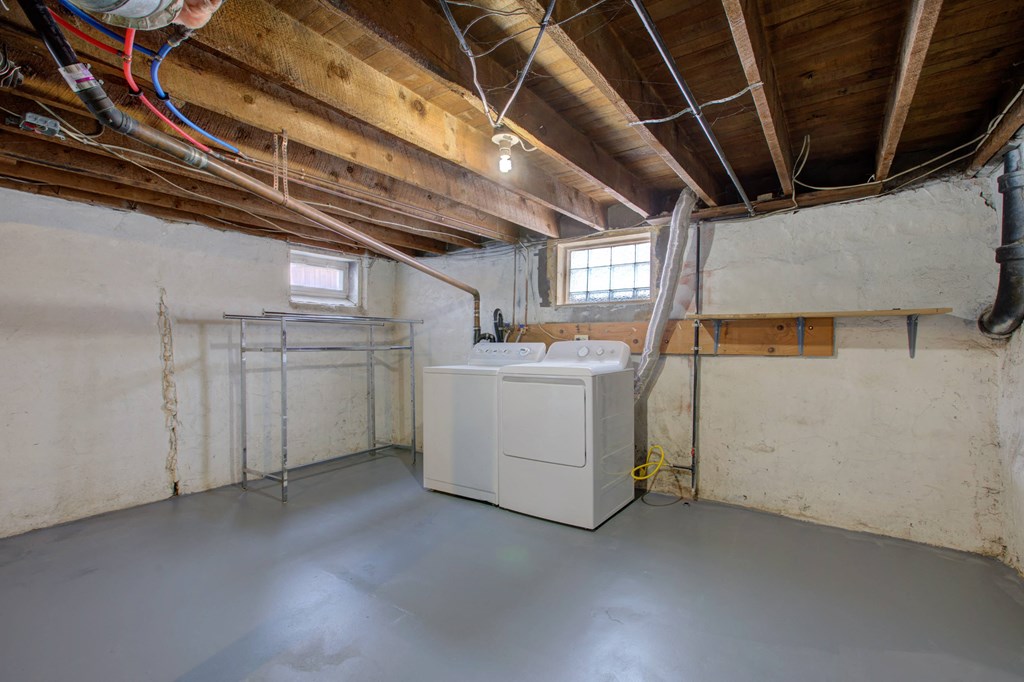a basement with a washer and dryer in it