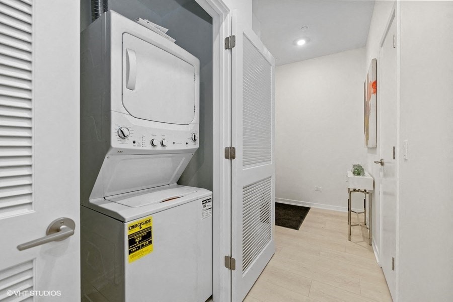 the laundry room has a washer and dryer and a door to the kitchen