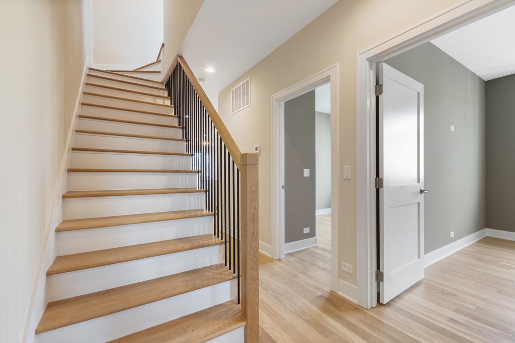 a view of a staircase in a home with wood floors and white walls