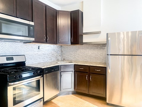 a kitchen with stainless steel appliances and wooden cabinets