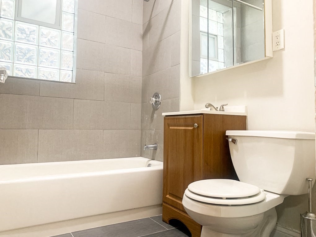 a bathroom with a toilet and a bath tub