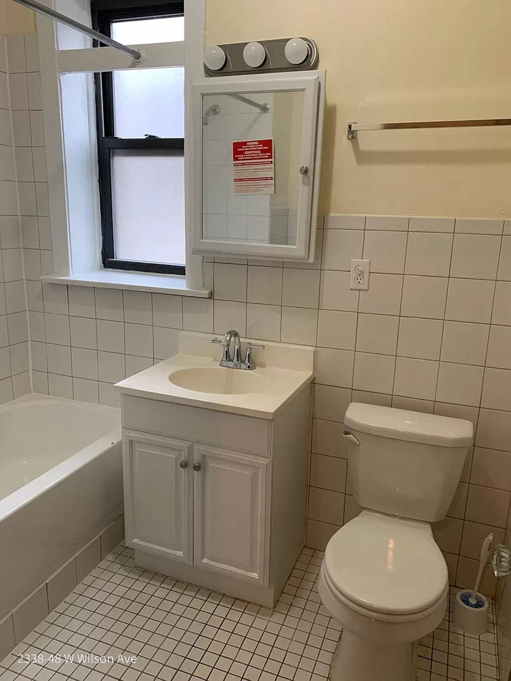 a bathroom with a toilet and a sink and a window