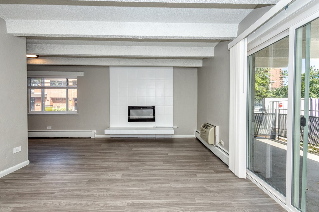 a living room with a large window and a fireplace