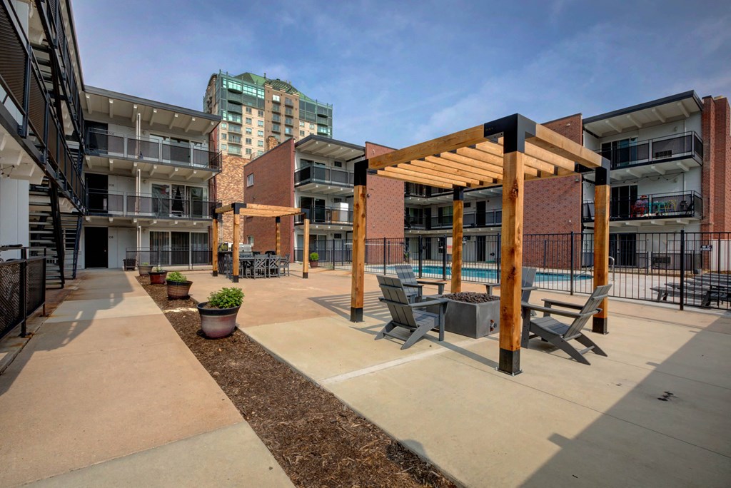 outdoor communal area with lounge space and grills and pool