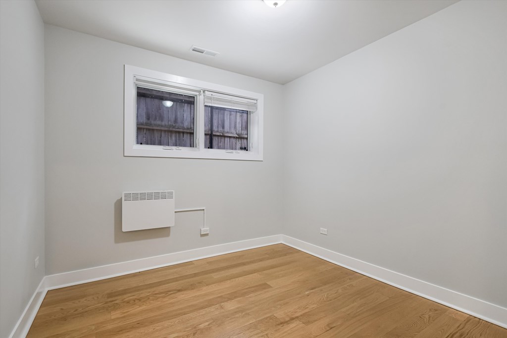 A room with a window and a radiator on the wall.