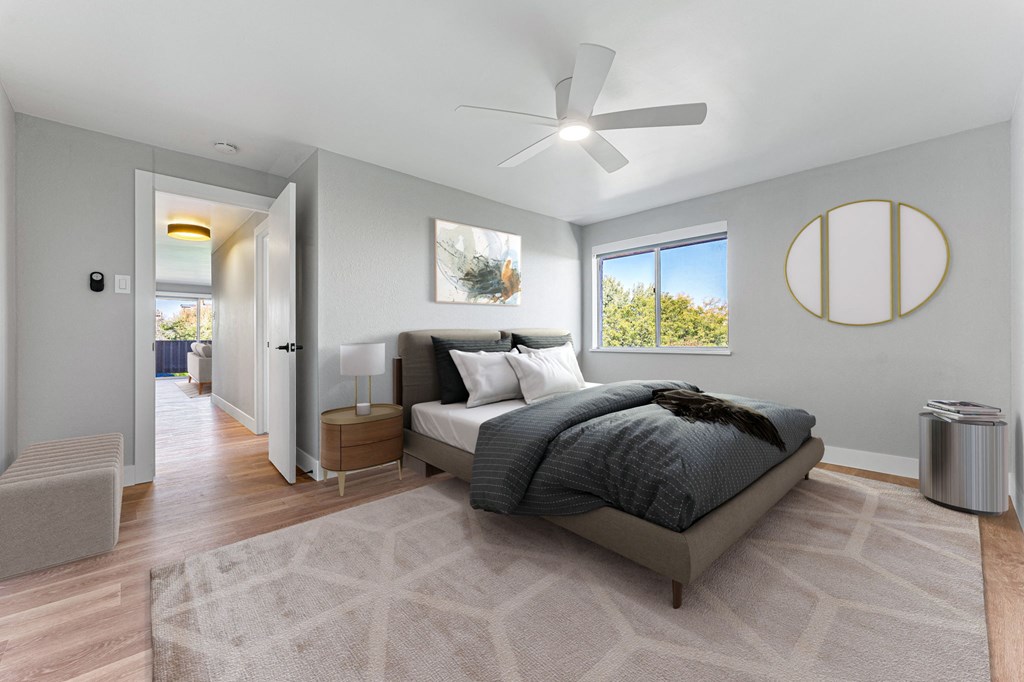 a bedroom with a bed and a ceiling fan