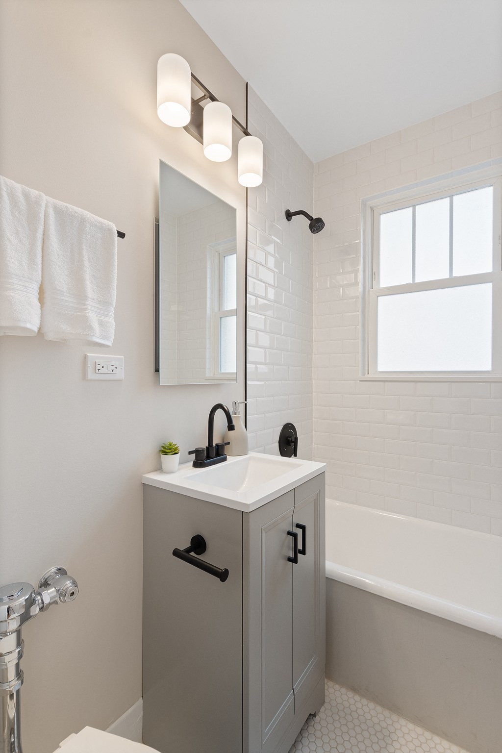 a small bathroom with a sink and a bath tub