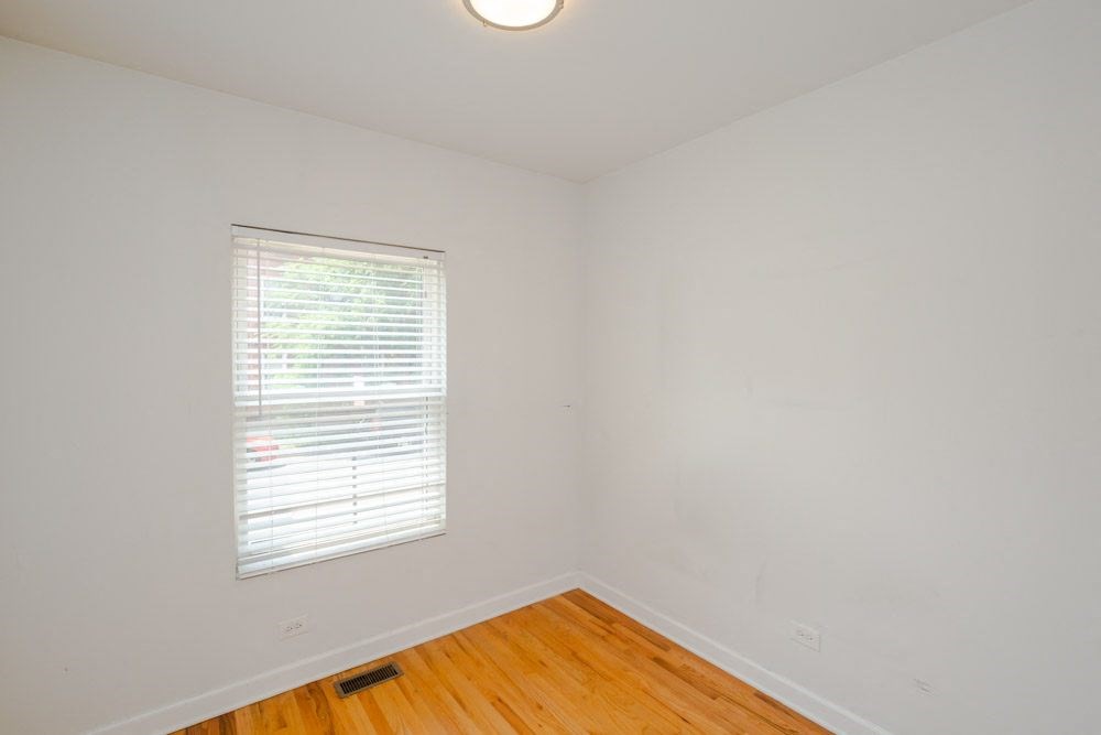 a room with a window and a wooden floor