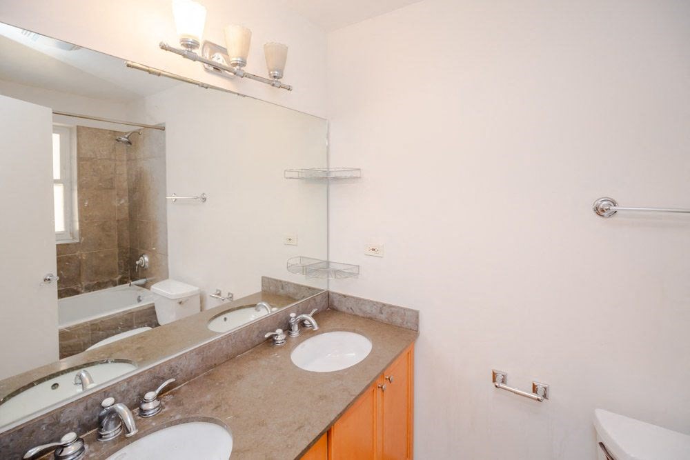 a bathroom with two sinks and a mirror