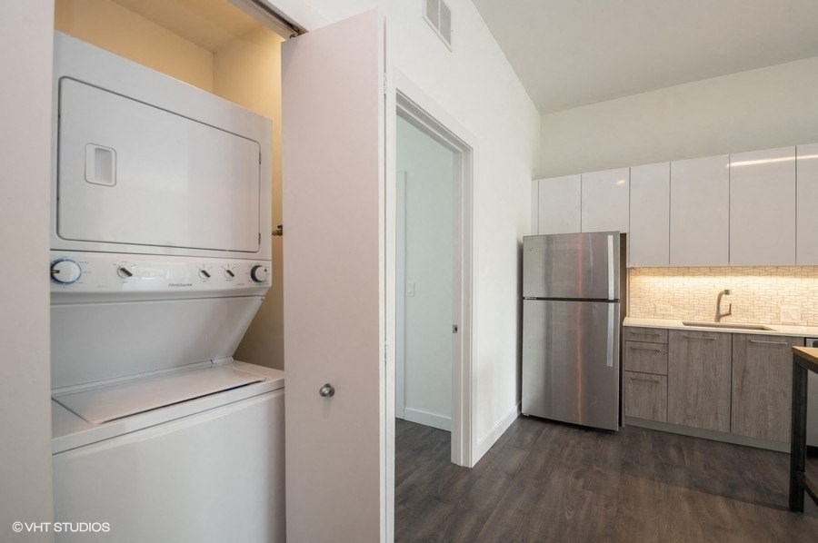 a kitchen with a refrigerator and a stove and