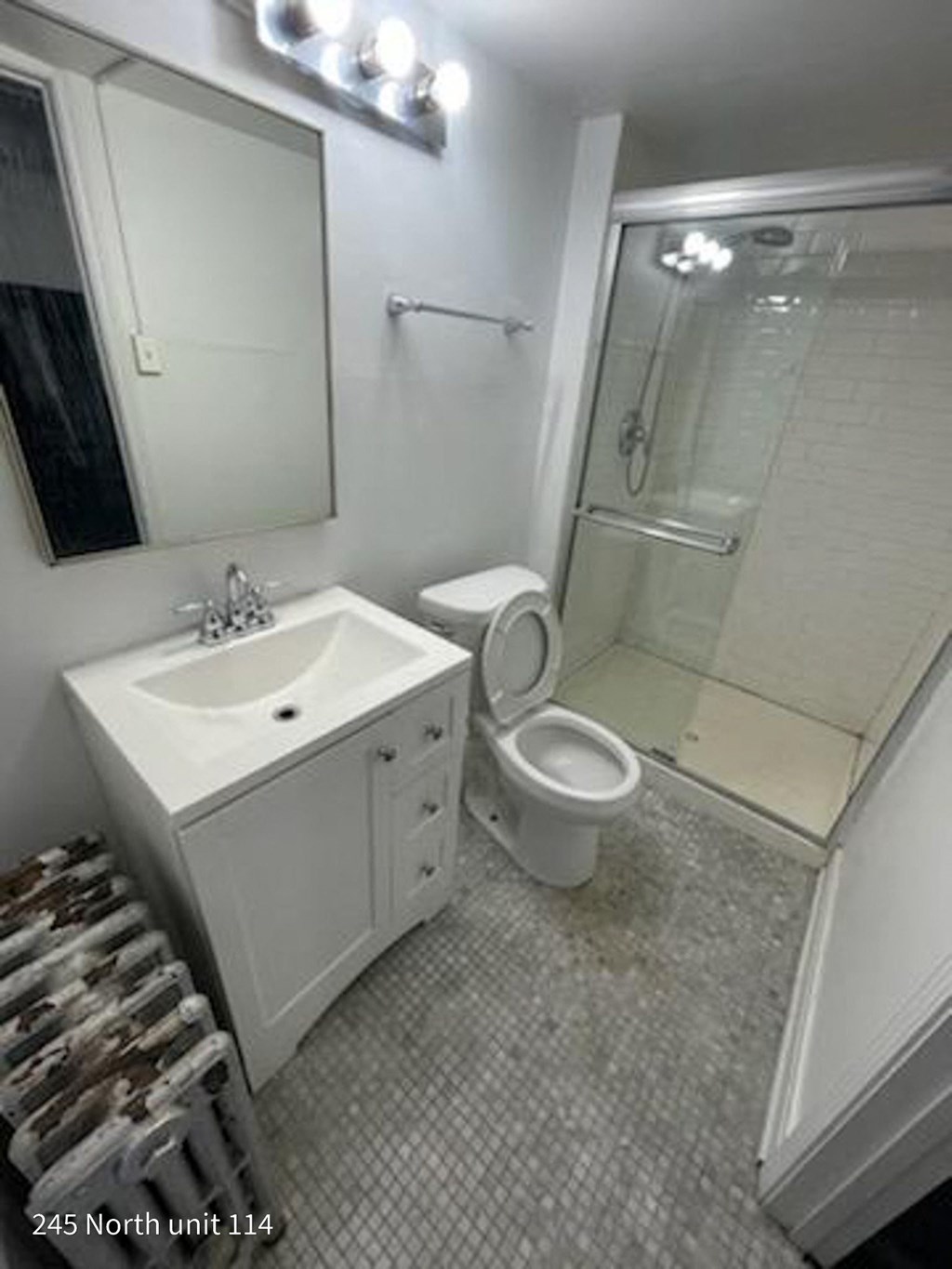 a bathroom with a sink toilet and a shower