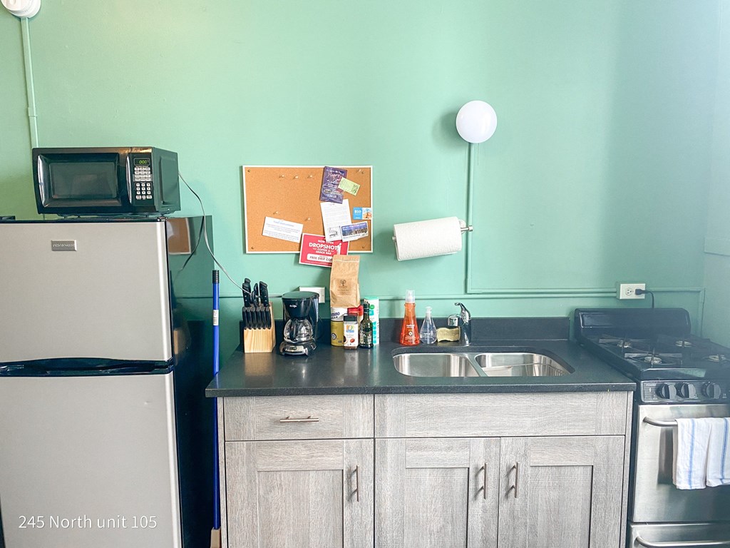 a small kitchen with a sink and a refrigerator