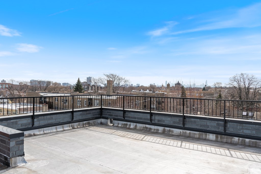 the balcony has a view of the city in the distance