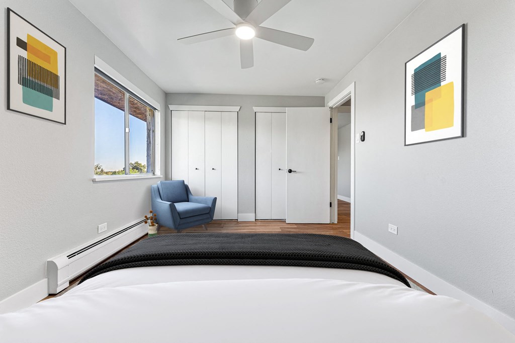 a bedroom with a large bed and a ceiling fan