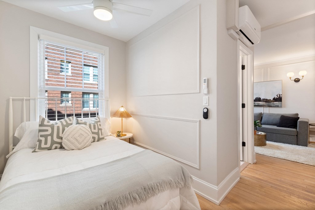 a bedroom with a bed and a window