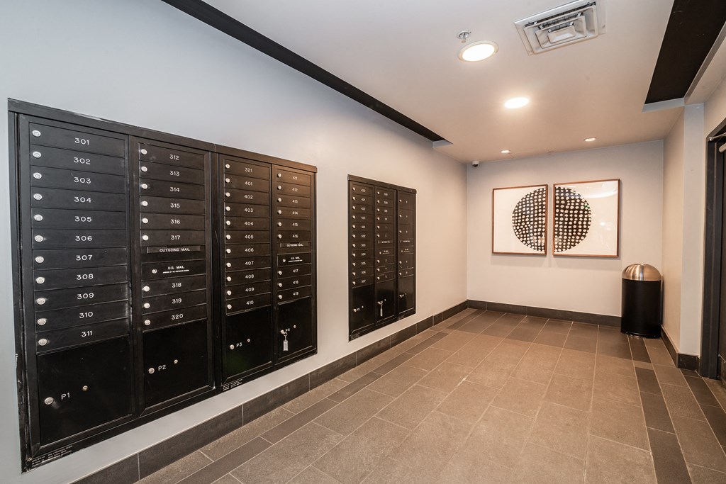 a lockers room with a painting on the wall and a tile floor