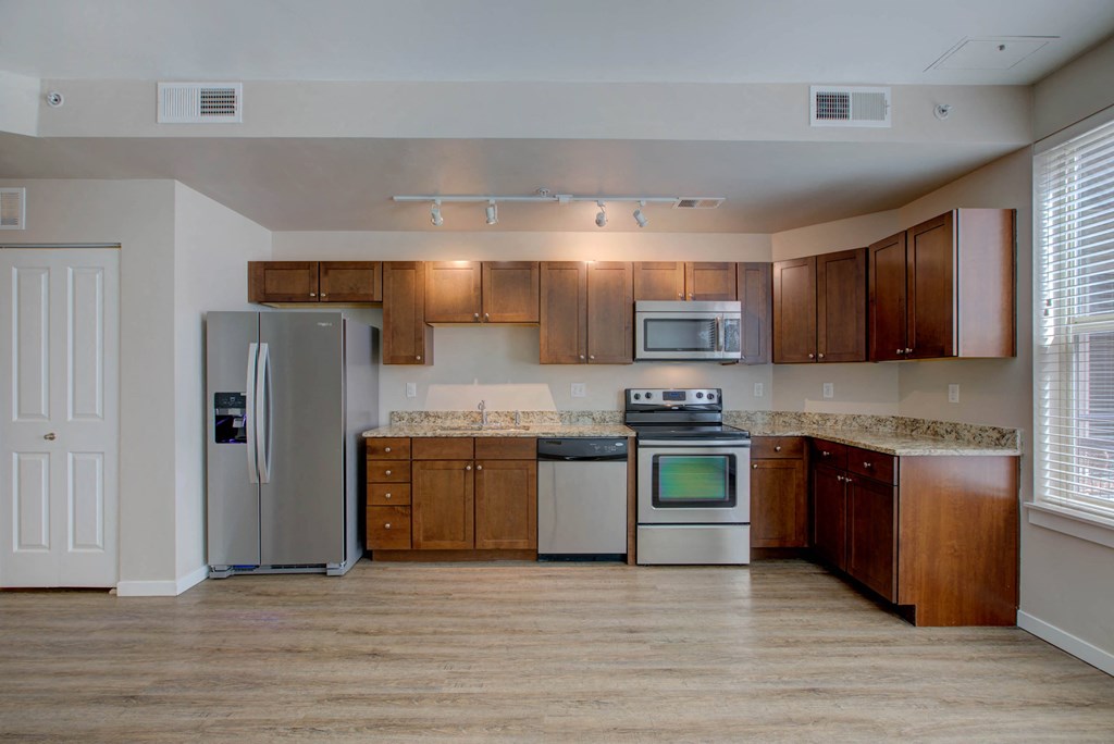 a kitchen with stainless steel appliances and wooden cabinets