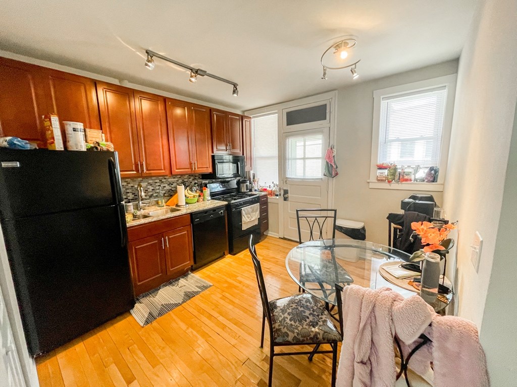 a kitchen and dining room with a glass table