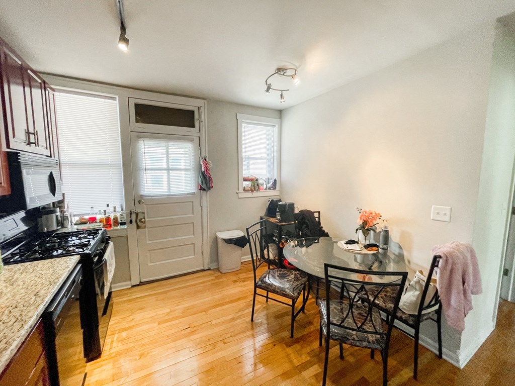 a kitchen and dining room with a table and chairs