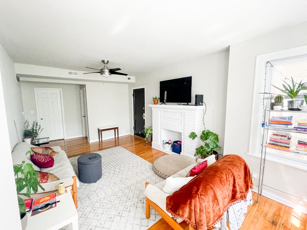a living room with a couch and a fireplace and a tv