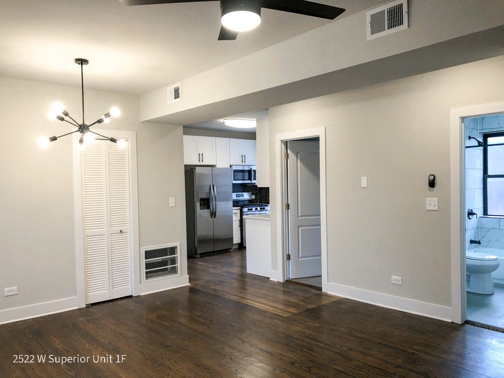 a living room with a hardwood floor and a ceiling fan