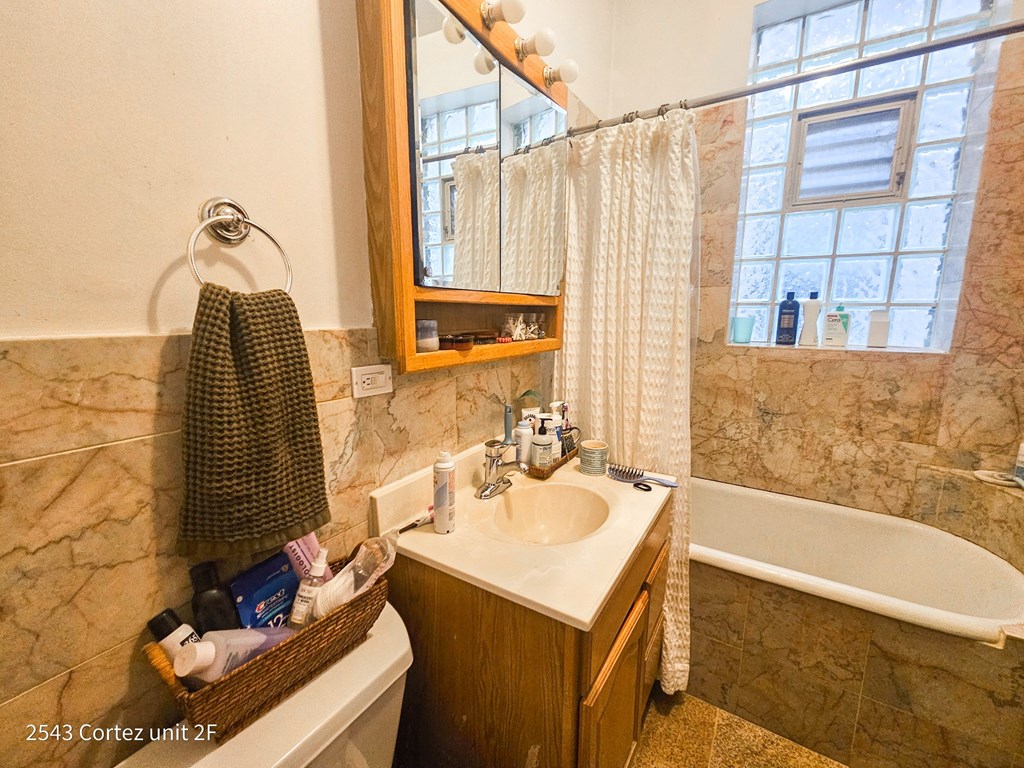 a bathroom with a sink and a tub and a mirror