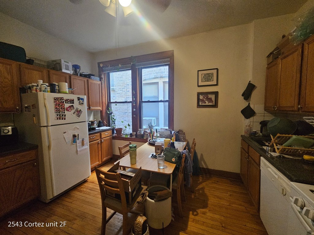 a kitchen with a dining table and a refrigerator