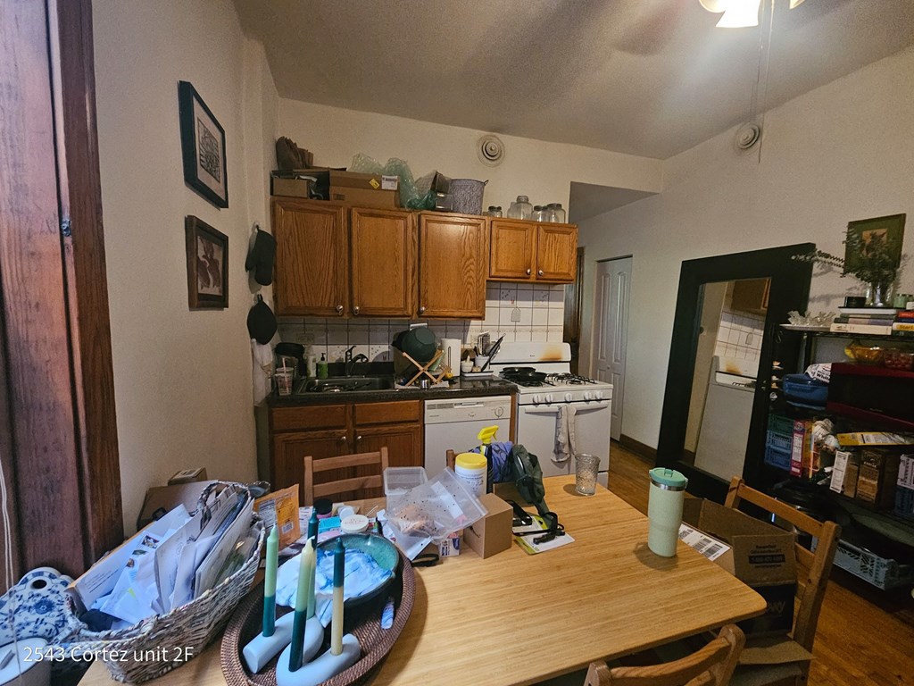 a kitchen and dining room with a table with a cake on it