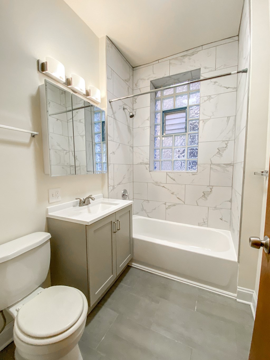A white toilet sits next to a sink in a bathroom.