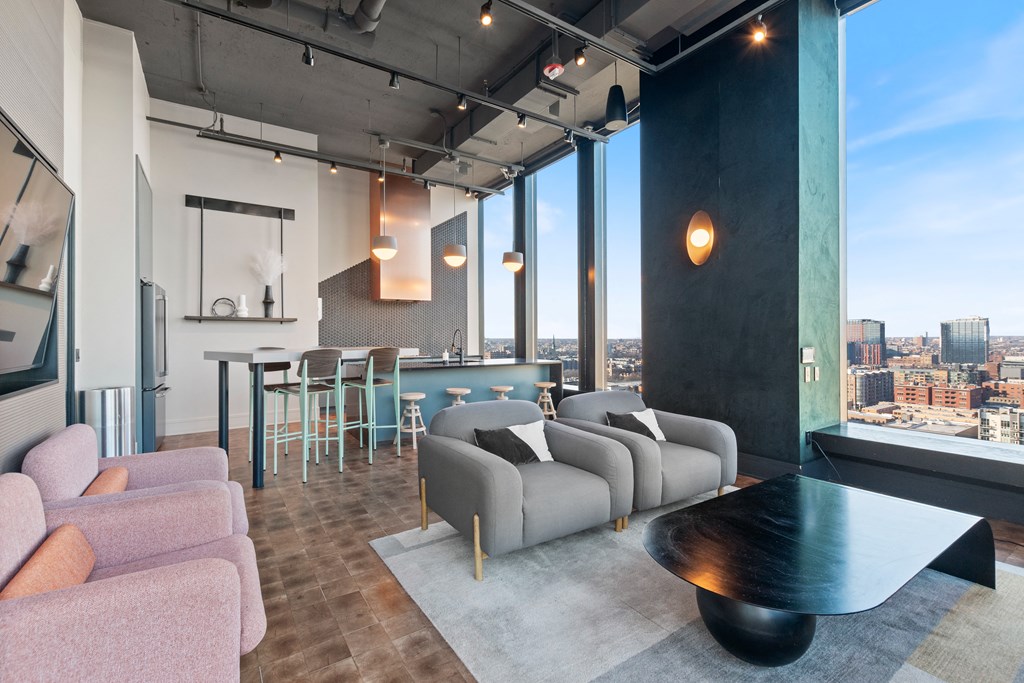 a resident lounge with couches and tables and a view of Chicago