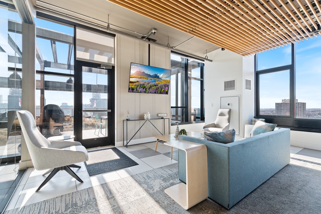 A modern living room with a large window and a view of the city.