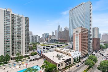 a view of the chicago skyline from a high rise building with a pool in the foreground