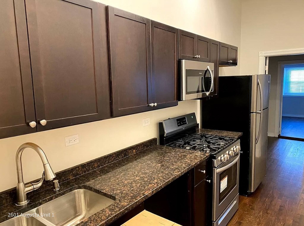 a kitchen with a granite counter top and a sink