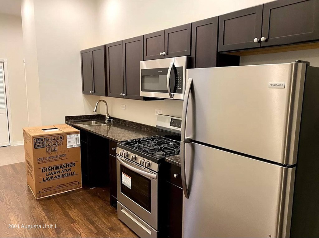 a kitchen with stainless steel appliances and black cabinets