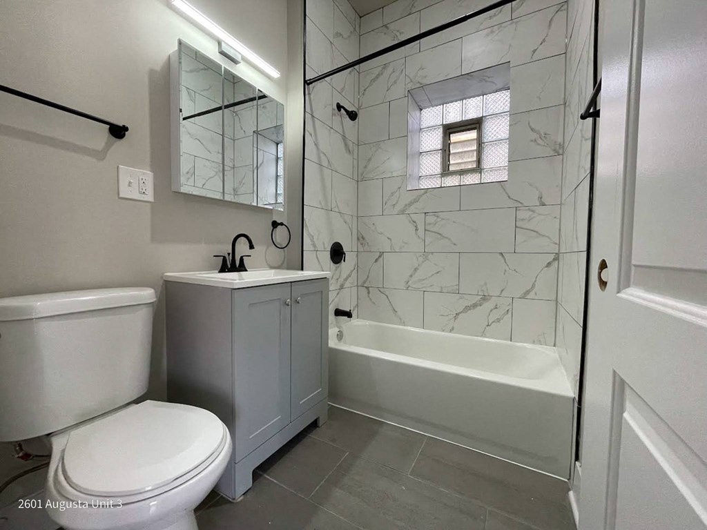 a bathroom with a toilet sink and a shower