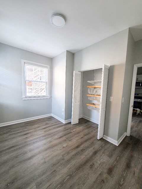 A kitchen with a refrigerator and a window.