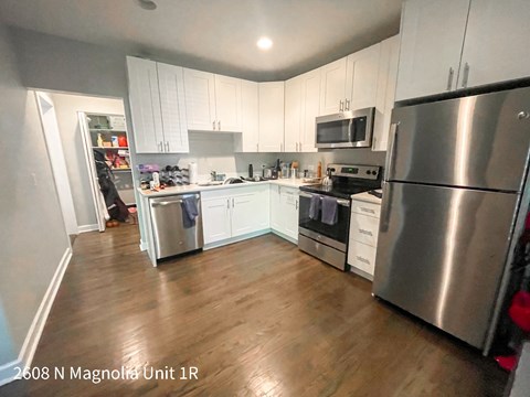 a kitchen with stainless steel appliances and white cabinets