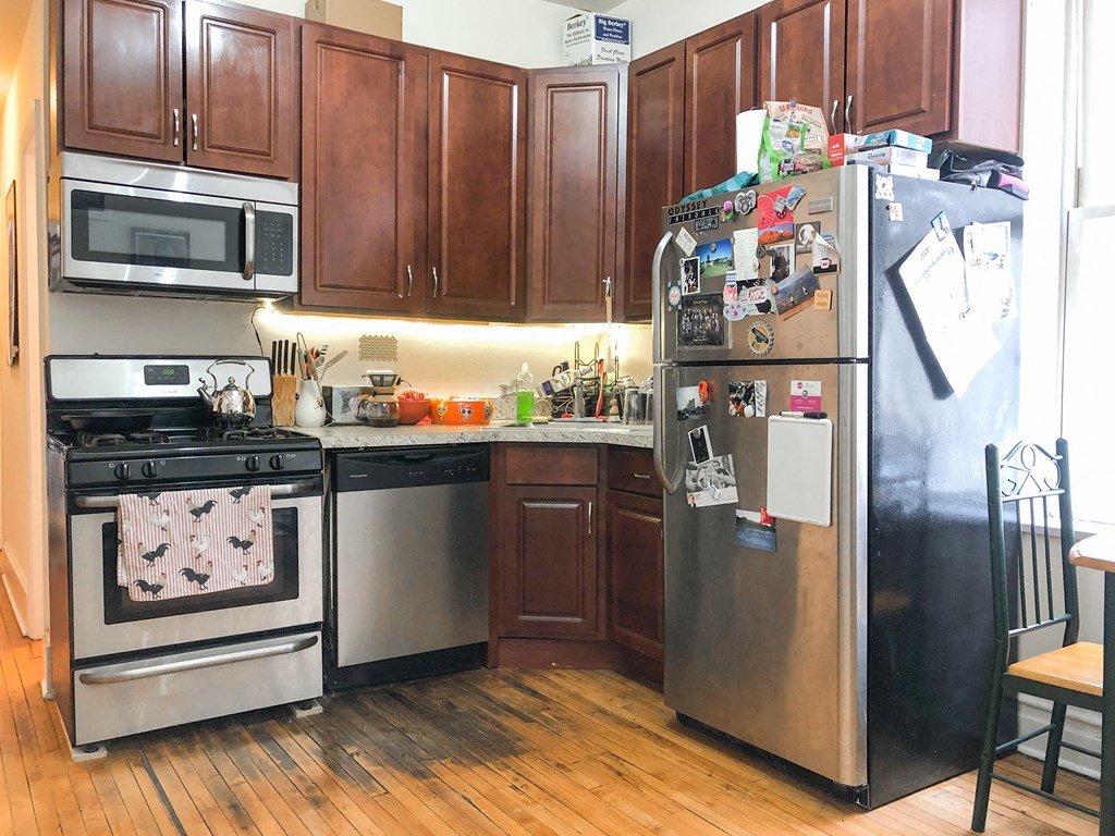a kitchen with stainless steel appliances and wooden cabinets