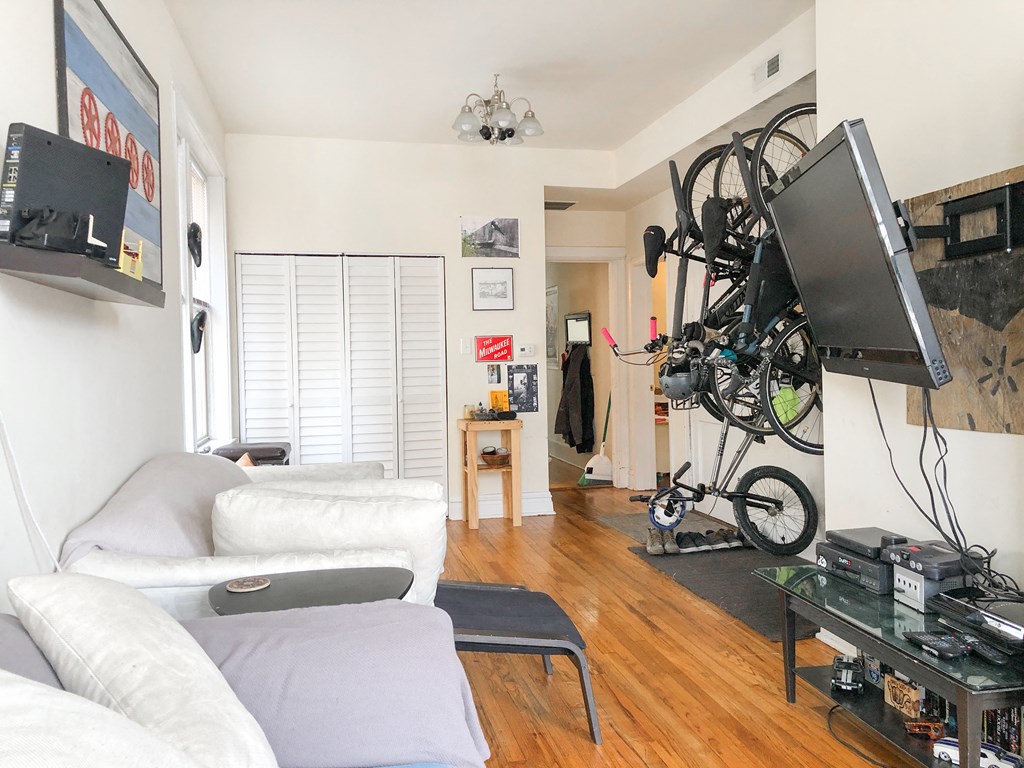 a living room with a white couch and a tv in a room