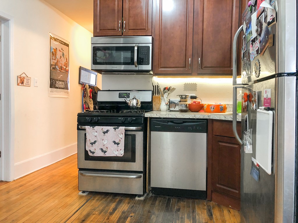 a kitchen with stainless steel appliances and wooden cabinets