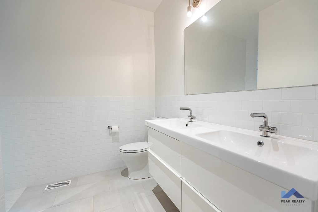 a white bathroom with a sink and a toilet