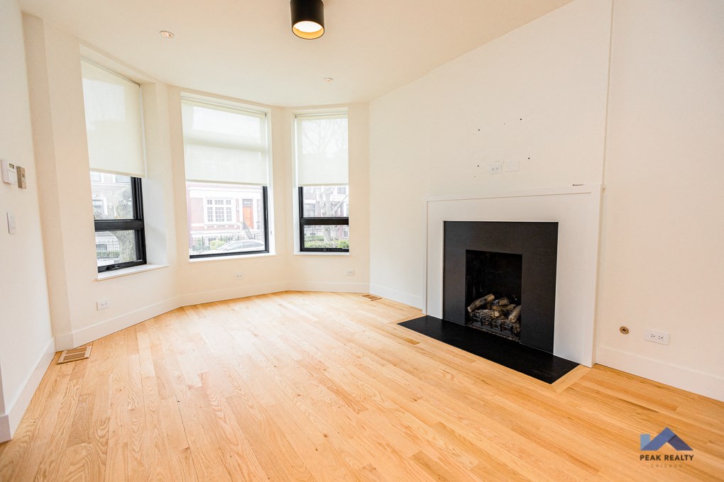 a living room with a fireplace and a wooden floor