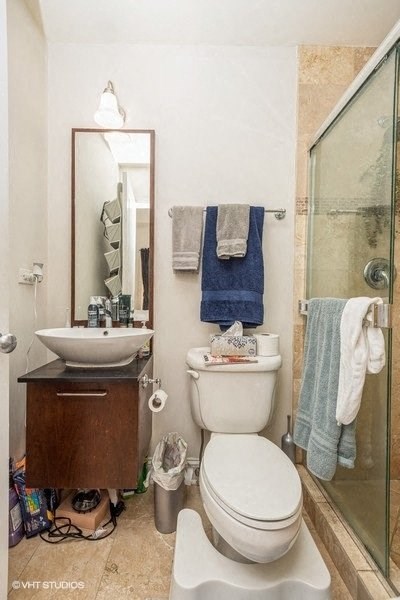 a bathroom with a toilet and a sink and a shower