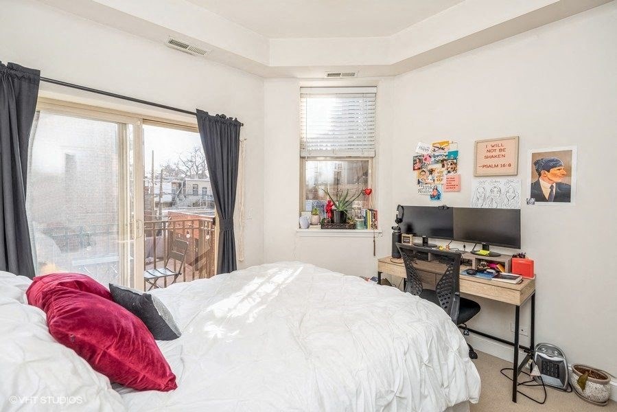 a bedroom with a bed and a desk and a tv