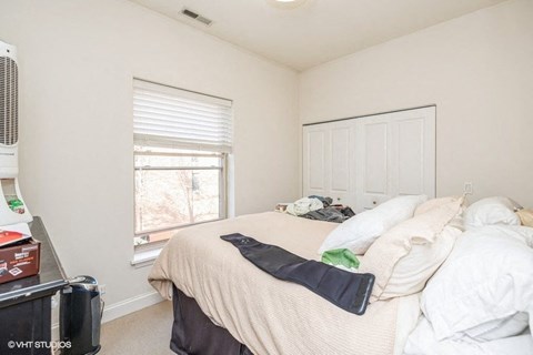 a small bedroom with a bed and a window