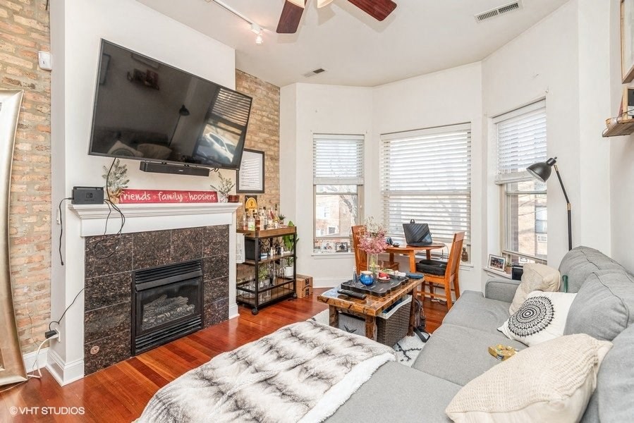 a living room with a couch and a fireplace and a television