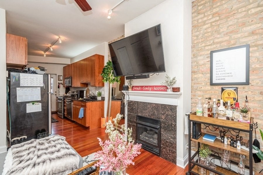 a living room with a fireplace and a tv above it