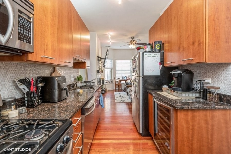 a kitchen with wooden cabinets and stainless steel appliances