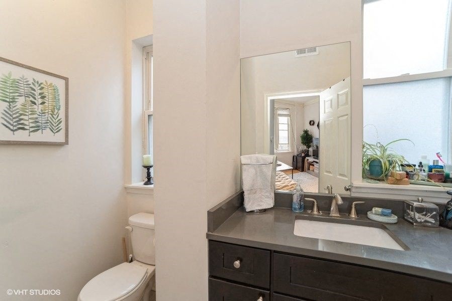 a bathroom with a sink and a toilet and a mirror